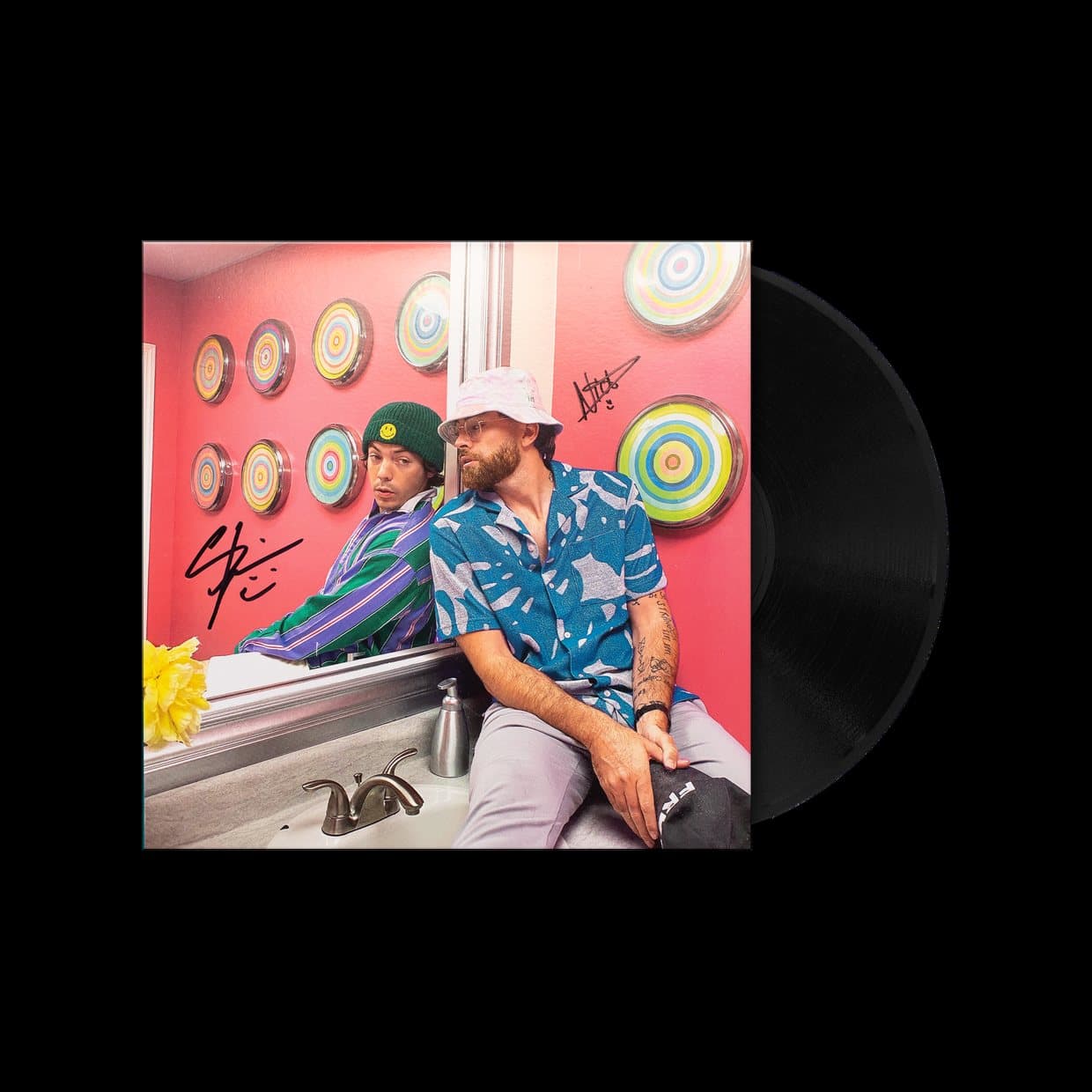The Iconic record sleeve on a black ground, two men sitting against a pink wall hung with records on its cover, the black vinyl drawn half out