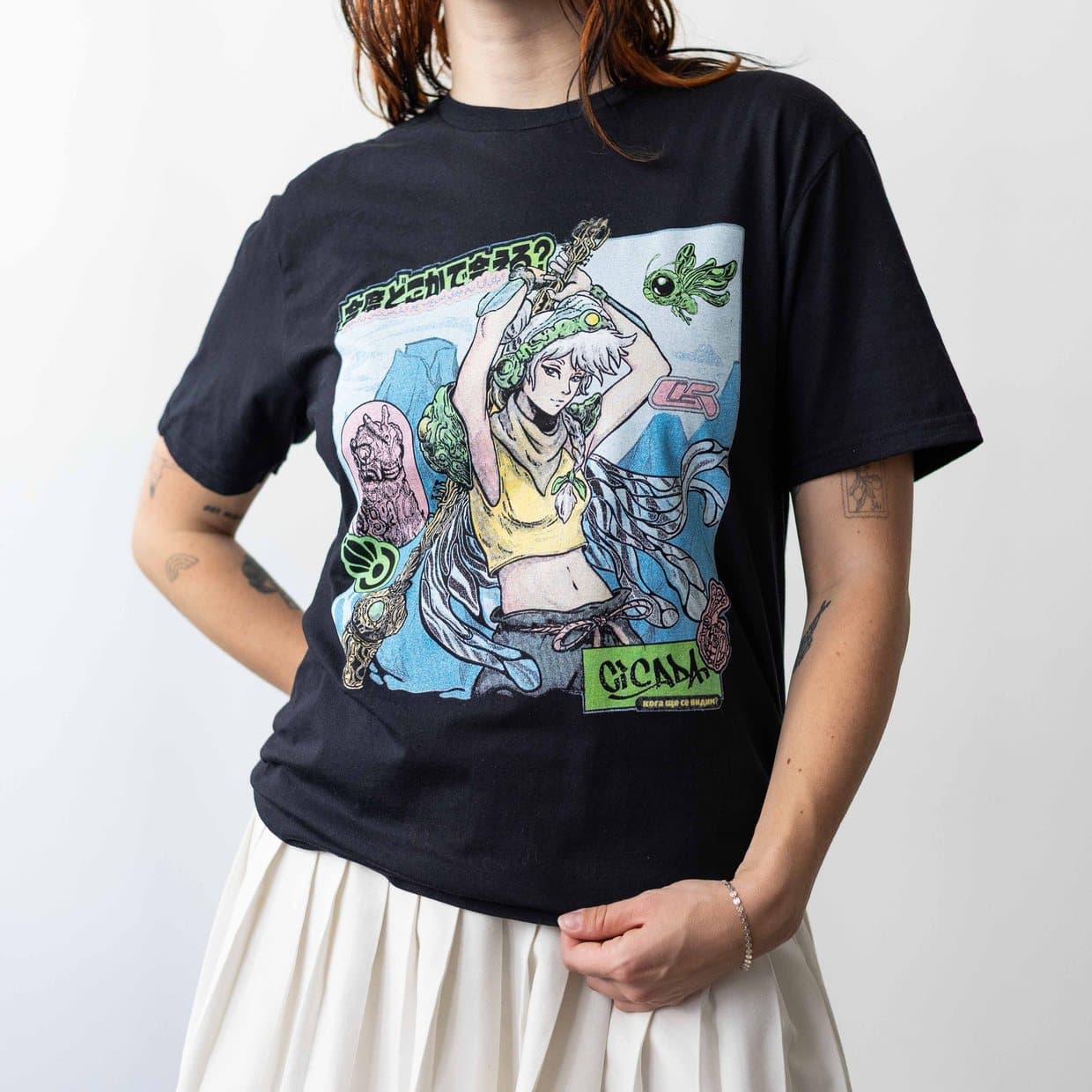 A woman wearing the black Ada tee, its printed graphic across the front