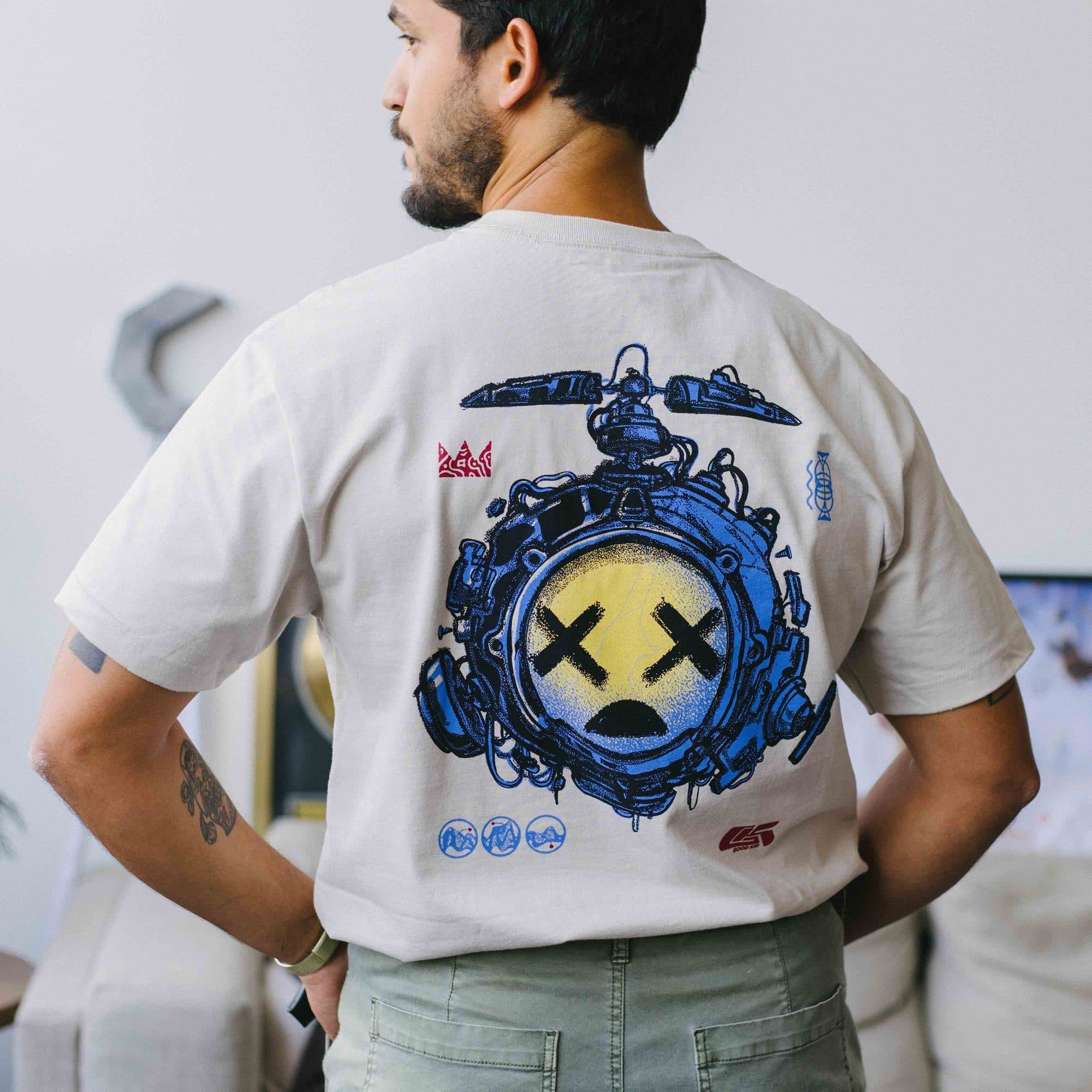 The back of the Good Kid Drone tee, worn, cream with a large blue print