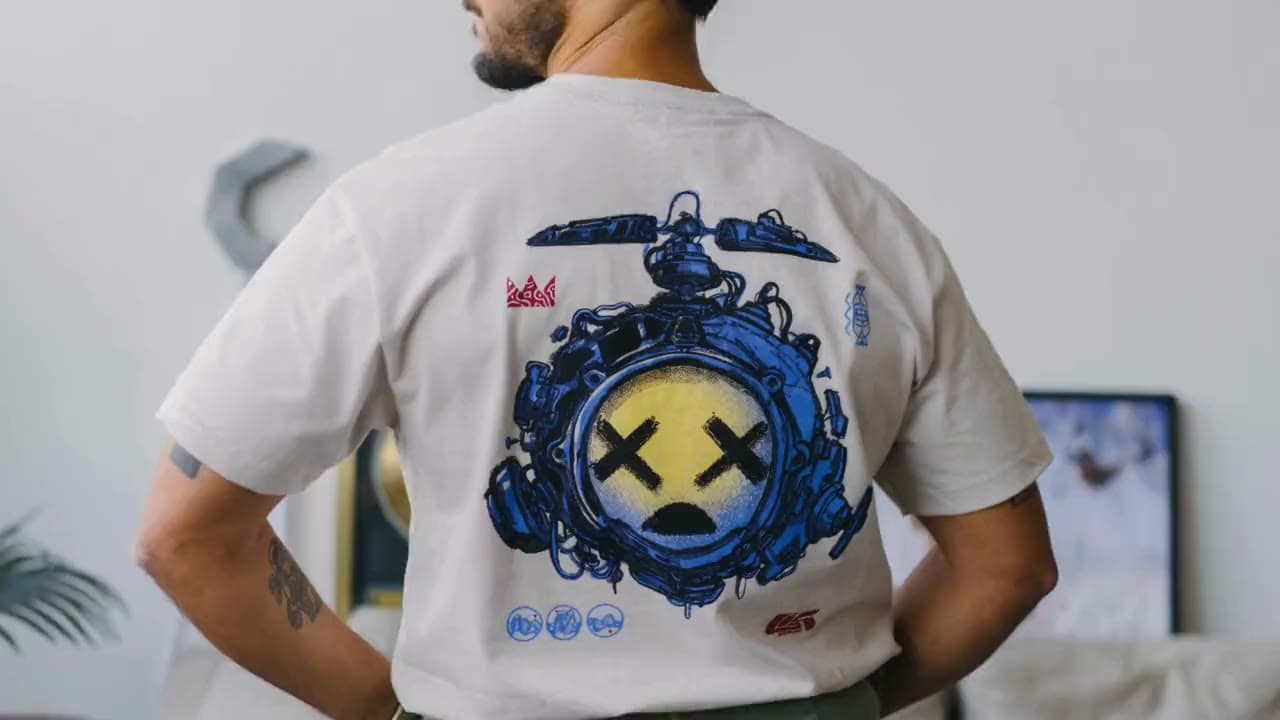 A man wearing the Good Kid Drone tee, seen from behind over his shoulder